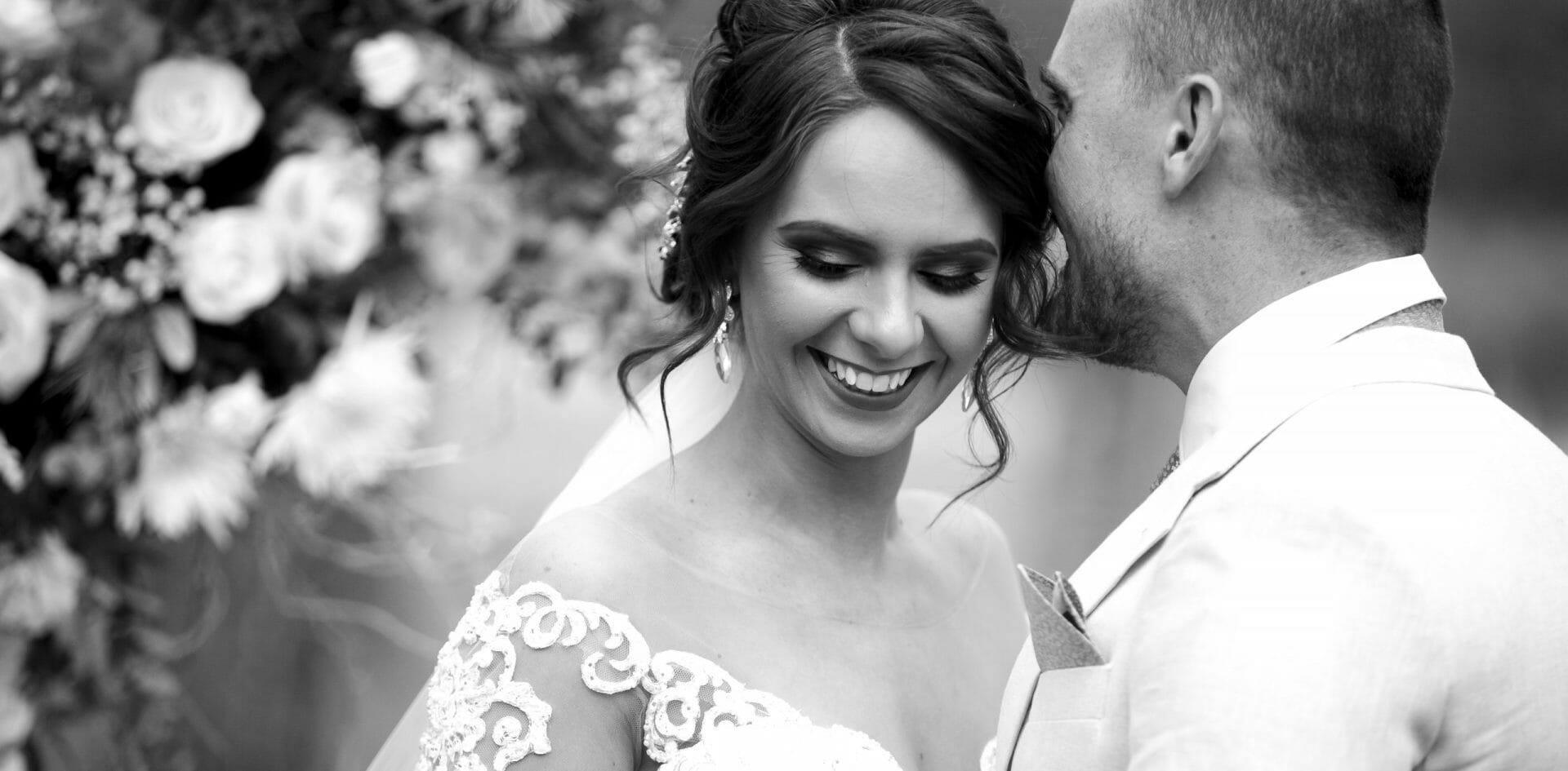 Groom whispering to bride close up portrait